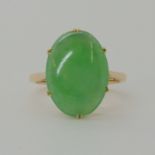 A 14CT GOLD CHINESE GREEN HARDSTONE RING approx dimensions of the hardstone 15mm x 11mm x 3.5mm,