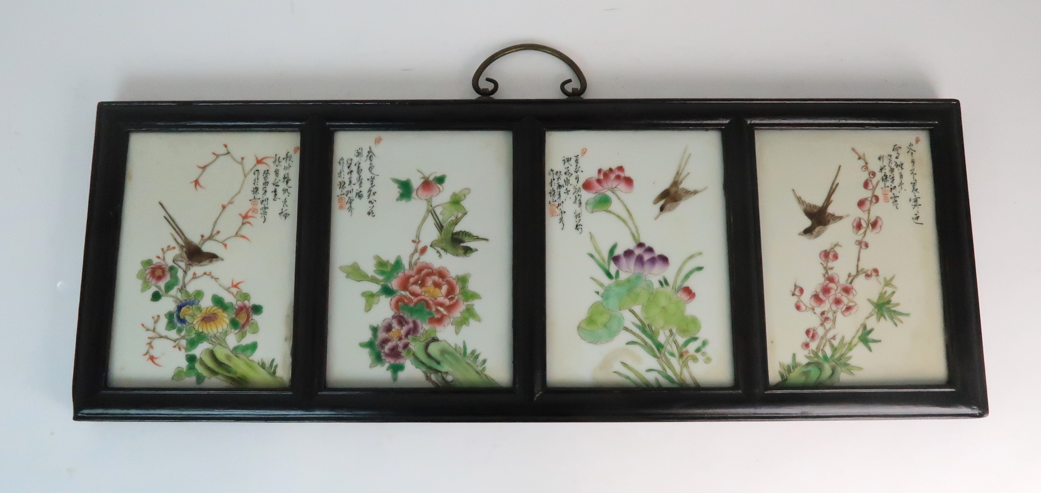 A CHINESE TILE PAINTING the four tiles painted with birds amongst flowers and script, signed, each