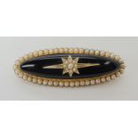 A 15CT GOLD MOURNING BROOCH set with pearls and onyx, dimensions 5.2cm x 1.8cm. Weight 13gms