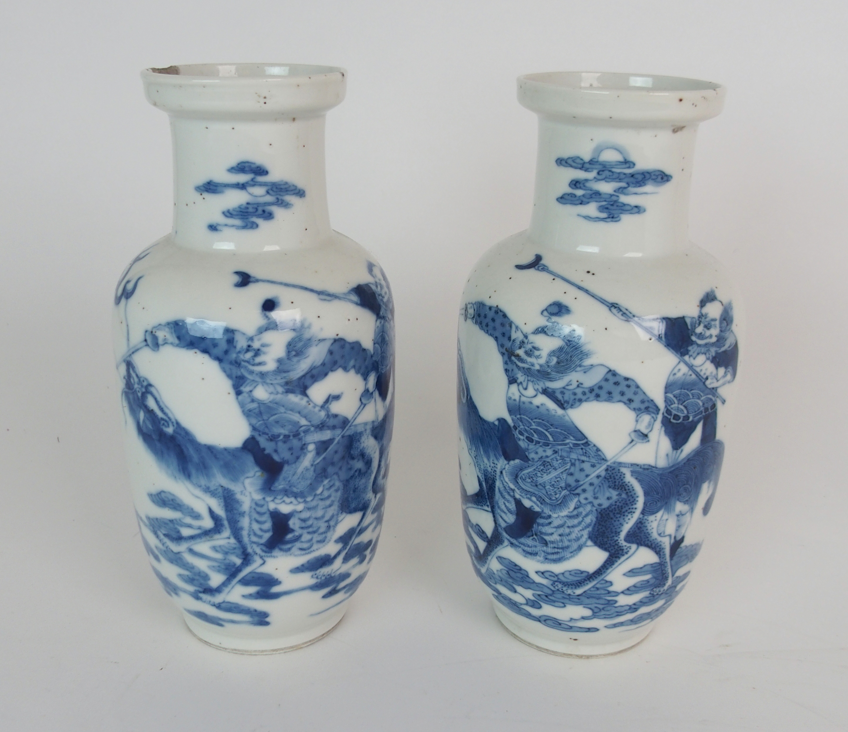 A PAIR CHINESE BLUE AND WHITE BALUSTER VASES painted with warriors astride mythical beasts,