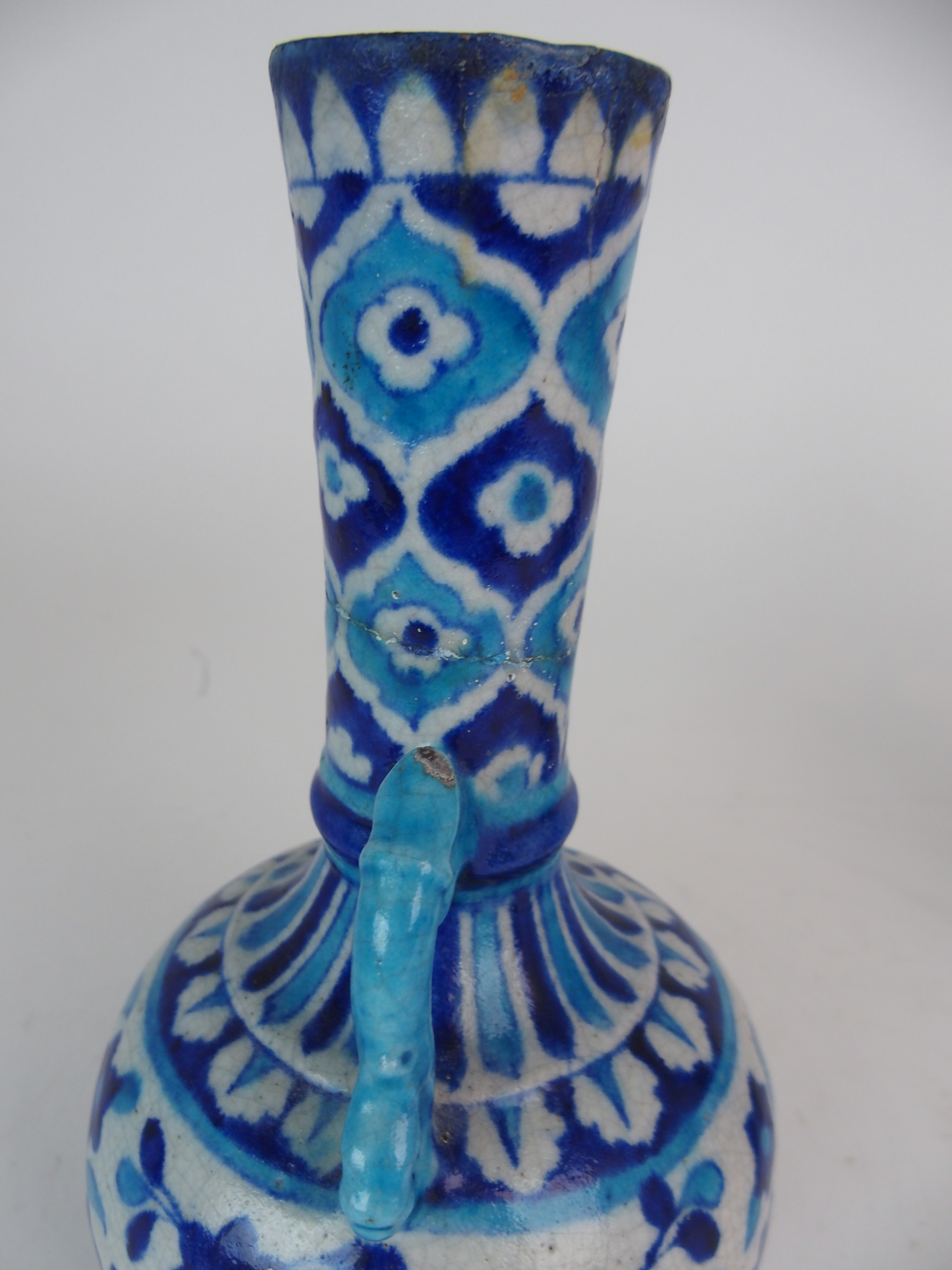 A PAIR OF PERSIAN POTTERY BLUE AND WHITE TWO HANDLED VASES painted with flowers and foliage, with - Image 6 of 11