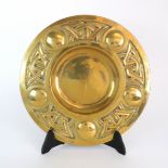A MARGARET GILMOUR ARTS AND CRAFTS BRASS DISH with celtic knotwork and roundel decoration,
