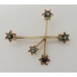 A 15CT GOLD SOUTHERN CROSS BROOCH set with green tourmalines, stamped 15ct Suha D & Co to the