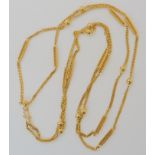 A BRIGHT YELLOW METAL DOUBLE LENGTH FANCY CHAIN with ball and fancy baton links, can be worn in