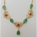 A 15CT GOLD RUBY EMERALD AND PEARL SET MOTH NECKLACE stamped 15ct to the reverse and also the clasp,