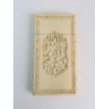A CANTON IVORY CARD CASE carved with a vignette with figures in a village the reverse with a cross