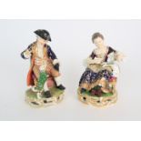 A PAIR OF DERBY PORCELAIN FIGURES early 19th century, modelled as a seated boy playing with a dog