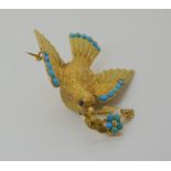 A VICTORIAN LOCKET BACK DOVE BROOCH SET WITH TURQUOISE craftsman made in yellow metal, with