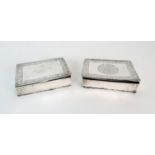 TWO PERSIAN WHITE METAL BOXES engraved with script and scrolling foliage, 3cm high, 11.5cm wide
