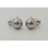 A PAIR OF 18CT WHITE GOLD PEARL AND DIAMOND EARRINGS the large grey pearls are approximately 10.