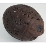 A CARVED COCONUT BUG BEAR MONEY BANK decorated with figures and foliage, 14cm wide Condition Report: