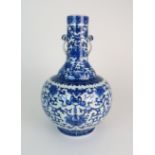 A CHINESE BLUE AND WHITE BALUSTER VASE painted with peonies and scrolling foliage, within formal