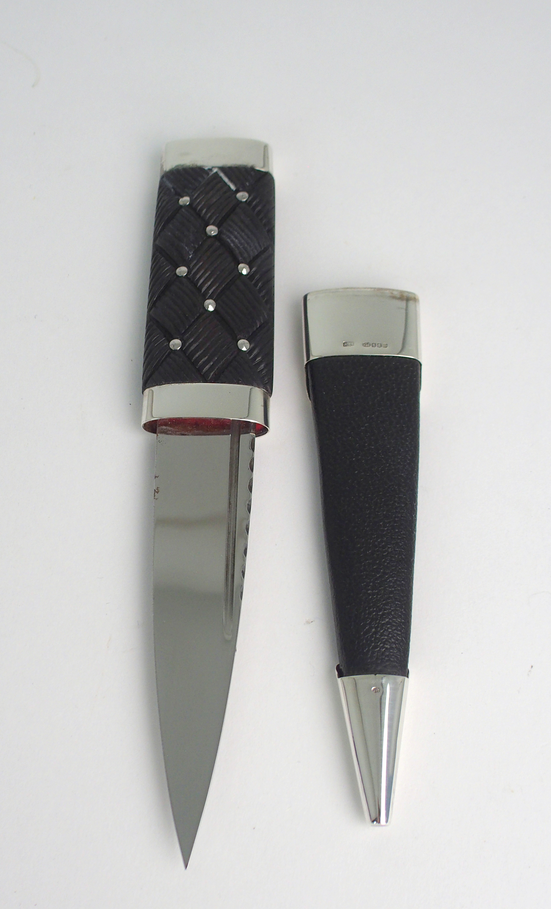 A SILVER-MOUNTED SGIAN DUBH BY HAMILTON & INCHES with black goatskin scabbard and hand carved