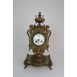 A FRENCH ONYX AND ORMOLU MOUNTED MANTLE CLOCK the enamelled dial with Roman numerals and swags of