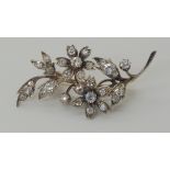 A DIAMOND FLOWER BROOCH mounted in yellow & white metal, set with estimated approx 1.34 carats of