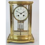 A FRENCH FOUR GLASS AND BRASS MANTLE CLOCK the white enamel dial with arabic numerals and swags of