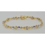 AN 18CT YELLOW AND WHITE GOLD HEART PATTERN DIAMOND BRACELET set with estimated approx 0.80cts of