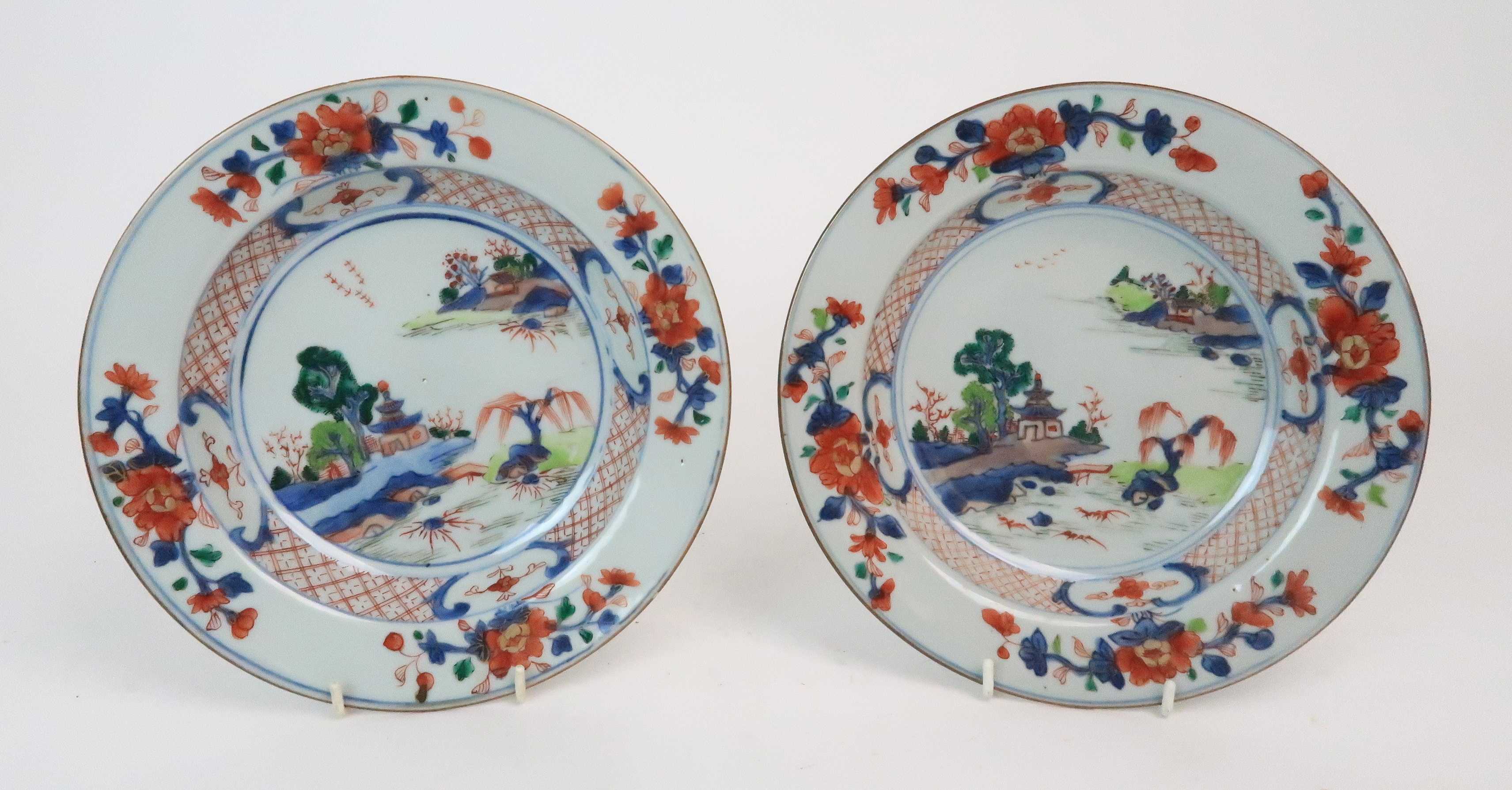 *WITHDRAWN* A PAIR CHINESE IMARI EXPORT PLATES painted with pagodas on islands, within diaper