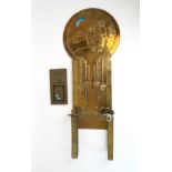 A SCOTTISH BRASS ARTS AND CRAFTS WALL SCONCE with two candle arms, the back plate decorated in