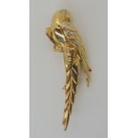 AN 18CT GOLD AND DIAMOND MACAW PARROT BROOCH with diamond set eyes and wings. Made by Preston's of