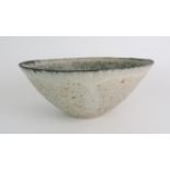 •BETTY BLANDINO (1927-2011) A stoneware bowl with slipware glaze, impressed mark to base, 32cm