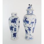 A CHINESE BLUE AND WHITE BALUSTER VASE AND COVER painted with numerous figures within foliate
