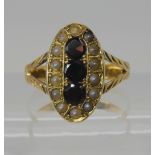 A VICTORIAN GARNET AND PEARL RING the Victoria head is still visible on the hallmark, set in