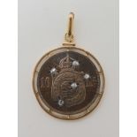 A YELLOW METAL MOUNTED 1869 BRAZILIAN COIN SET WITH DIAMONDS a Petrus II 10 Reis coin, cut with star