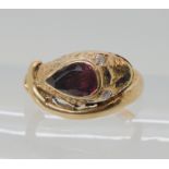 A 9CT ROSE GOLD GARNET AND DIAMOND SNAKE RING finger size J, weight 4.5gms Condition Report: Has