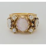 A YELLOW METAL CAMEO TRIO AND PEARL RING with engraved textured shank. Finger size O, weight 11.6gms