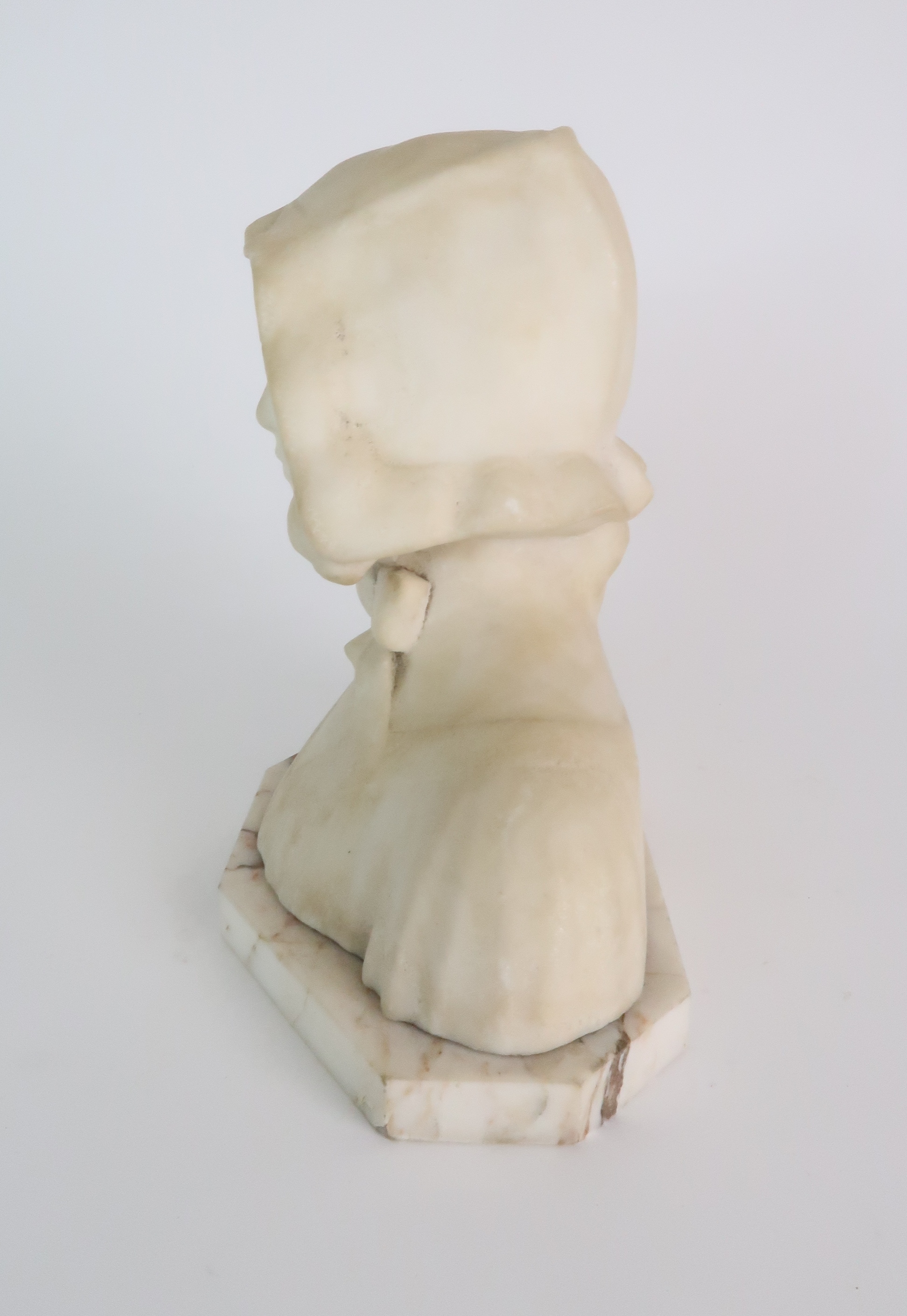 AN ALABASTER BUST OF A GIRL IN A BONNET upon onyx base, 20cm high Condition Report: Available upon - Image 2 of 6