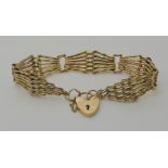 A 9CT GOLD FANCY GATE BRACELET length approx 19cm, with a heart shaped clasp, weight 12.7gms