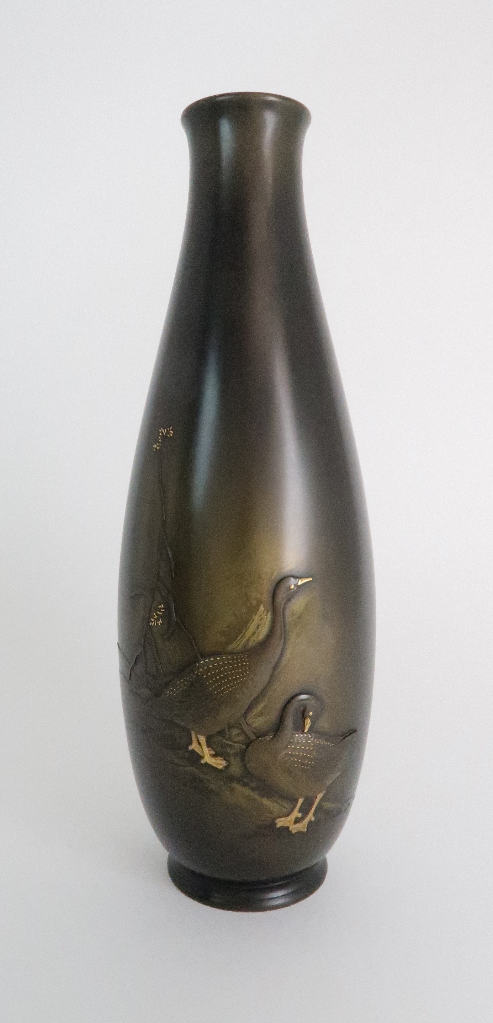 A JAPANESE BRONZE BALUSTER VASE cast with two geese beside foliage, signed, 39cm high Condition