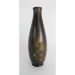 A JAPANESE BRONZE BALUSTER VASE cast with two geese beside foliage, signed, 39cm high Condition