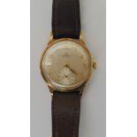 A 9CT GOLD GENTS VINTAGE OMEGA AUTOMATIC with silvered dial, gold coloured numbers and hands and a