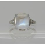 A PLATINUM ART DECO SUGAR LOAF CUT MOONSTONE AND DIAMOND RING the moonstone measures approx 10.4mm x