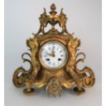 A FRENCH GILT METAL CLOCK the white dial with blue Roman Numerals, flanked either side by cherubs