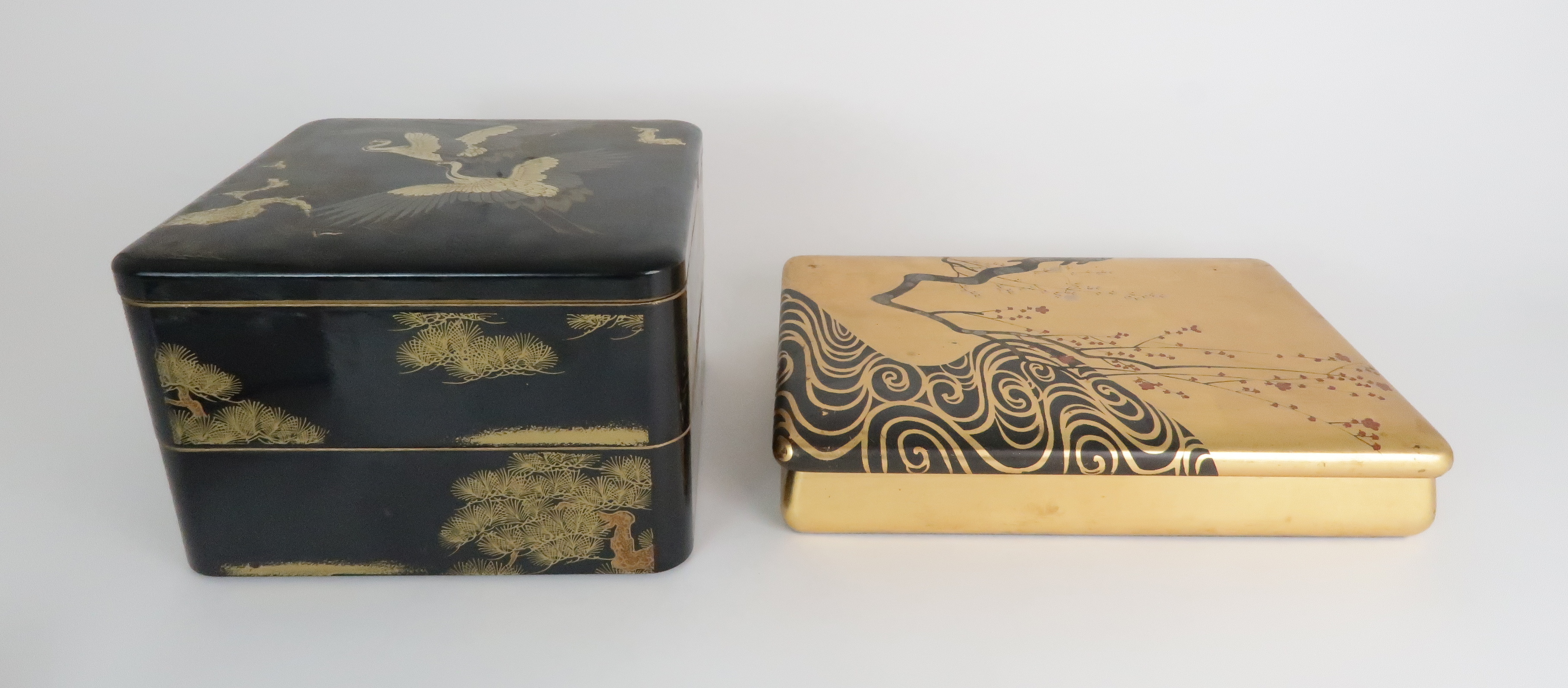 A JAPANESE LACQUERED BOX with two sections, painted with two storks amongst pine trees, 15cm high,