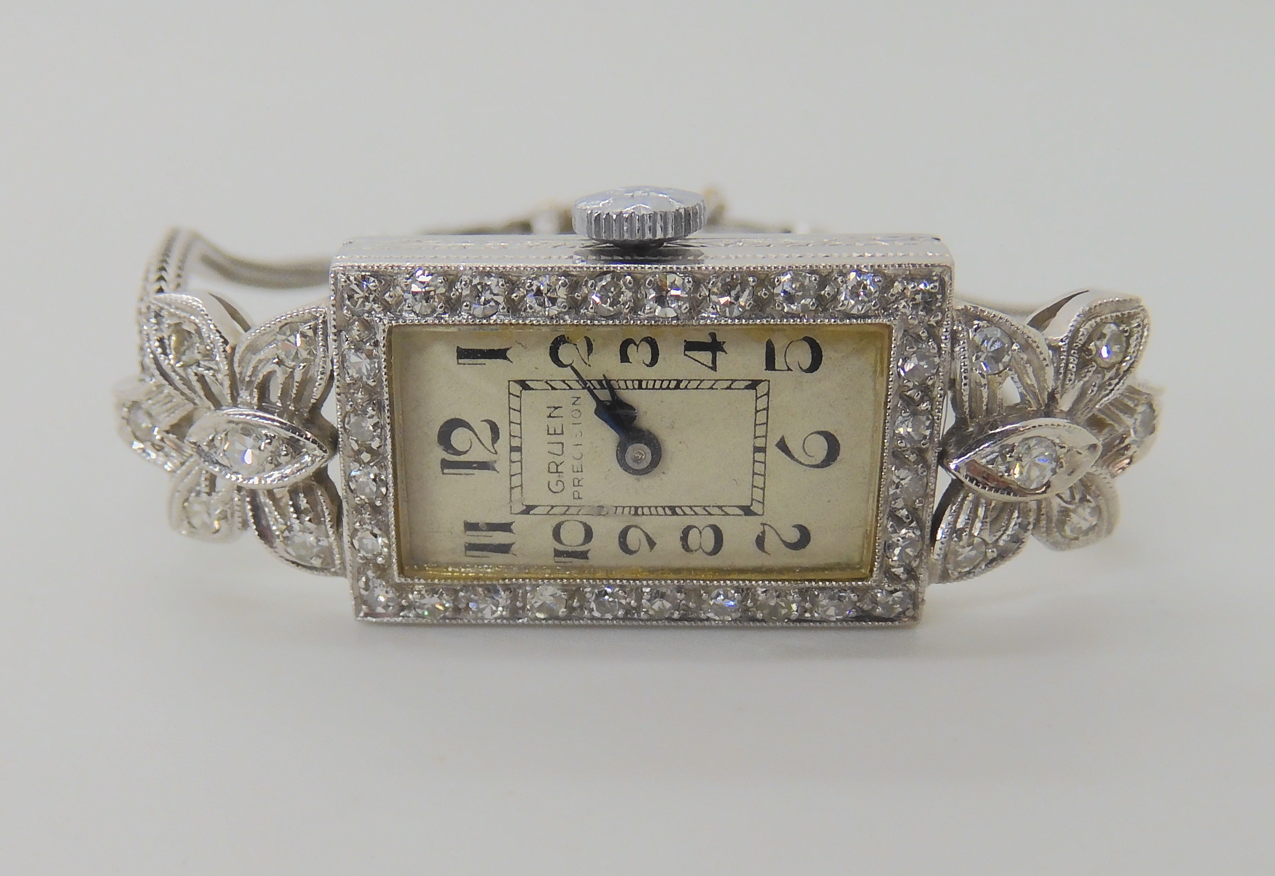 AN 18CT PLATINUM AND DIAMOND GRUEN COCKTAIL WATCH set with eight cut diamonds to the engraved