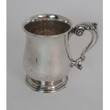 A SILVER TANKARD by William Neale & Son Ltd. Birmingham 1930, of baluster form the scrolling