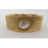 A 9CT GOLD RETRO BUECHE GIROD LADIES WATCH with integral bark textured strap, length 16cm width at