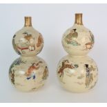 A PAIR OF SATSUMA DOUBLE GOURD VASES each painted with figures playing in gardens, with red and gilt