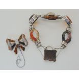 A CARVED SCOTTISH AGATE BRACELET AND BOW BROOCH the specimen agates are carved into an omega shape