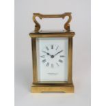 A GARRARD AND CO BRASS AND GLASS CARRIAGE CLOCK the white dial with Roman numerals and the