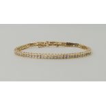 A 14K YELLOW GOLD DIAMOND TENNIS BRACELET set with estimated approx 1.57cts of brilliant cut