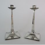 A PAIR OF ARTS AND CRAFTS SILVER CANDLESTICKS by James Dixon & Sons, Sheffield 1904 the fixed