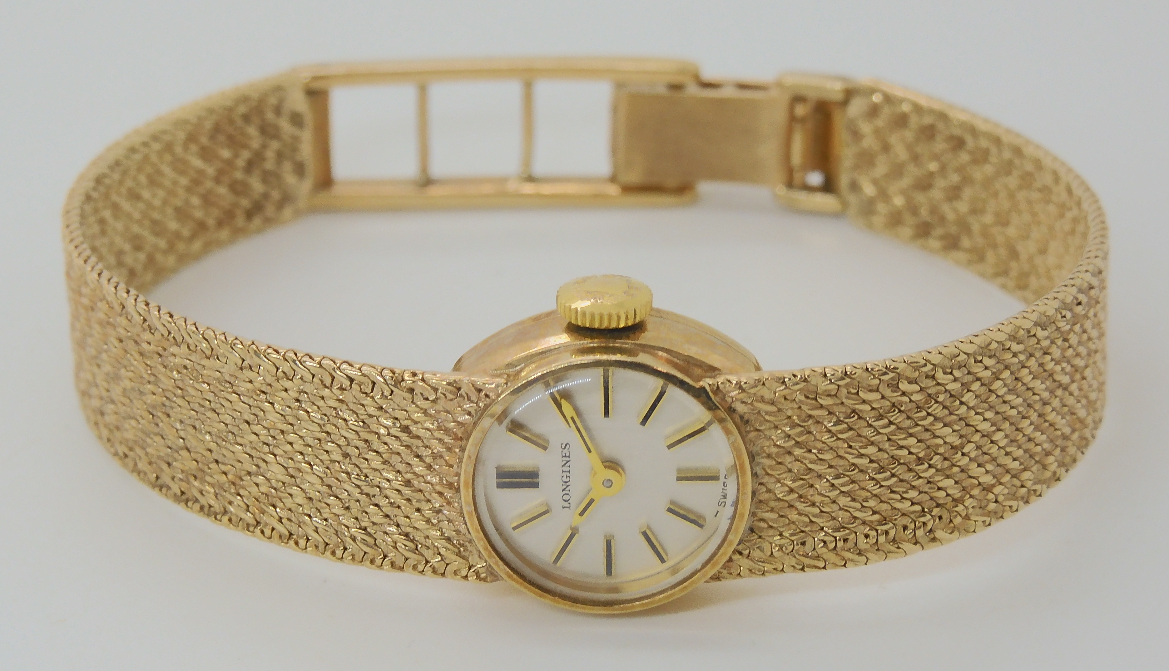 A 9CT GOLD LADIES LONGINES WRIST WATCH with integral plaited pattern strap, diameter of the dial 1.