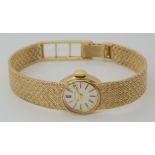 A 9CT GOLD LADIES LONGINES WRIST WATCH with integral plaited pattern strap, diameter of the dial 1.