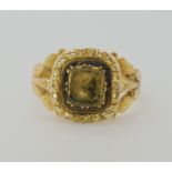 A BRIGHT YELLOW METAL VICTORIAN RING set with a foiled back citrine to the engraved and reeded