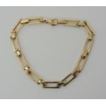 A 9CT GOLD FANCY LINK BRACELET with rectangular shaped links, length 19.5cm, weight 13.8gms